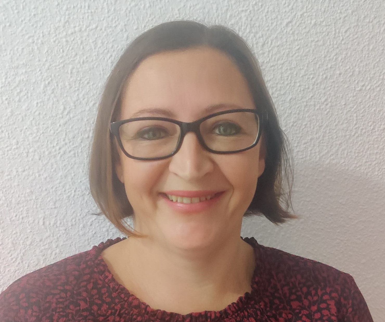 Picture of Ainslie, headshot only, , smiling.